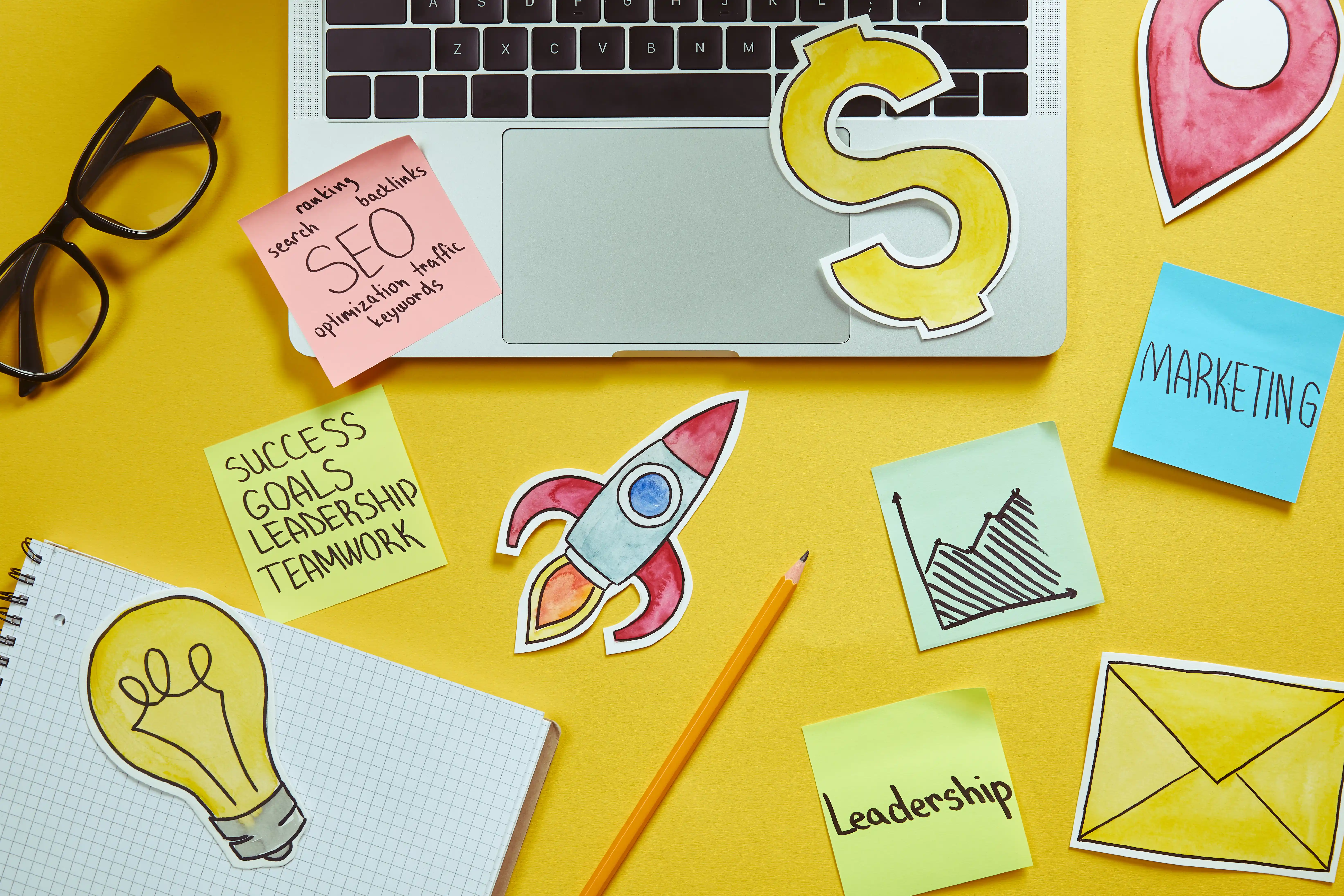 Creative desk with laptop, campaign notes, and planning stickers